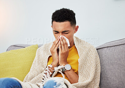 Buy stock photo Sick, couch and man blowing nose with flu, cold and sinus fever in a home living room with a blanket on a sofa. Healthcare, sneeze and young person with difficult symptoms or medical problem in house