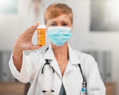 Buy stock photo Face mask, portrait or doctor with pills in hospital clinic for healthcare, medicine and supplements. Wellness, medication or hand of physician holding drugs, prescription product or tablet cure