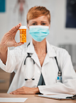 Buy stock photo Pills, portrait or doctor with medicine in hospital clinic for healthcare, wellness and supplements. Face mask, medication or female physician holding drugs, prescription product or tablet cure