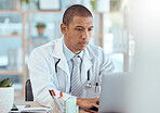 Doctor, man and typing on laptop in clinic for hospital management, healthcare research and telehealth. Male medical worker at computer for professional review, online services and medicine analysis