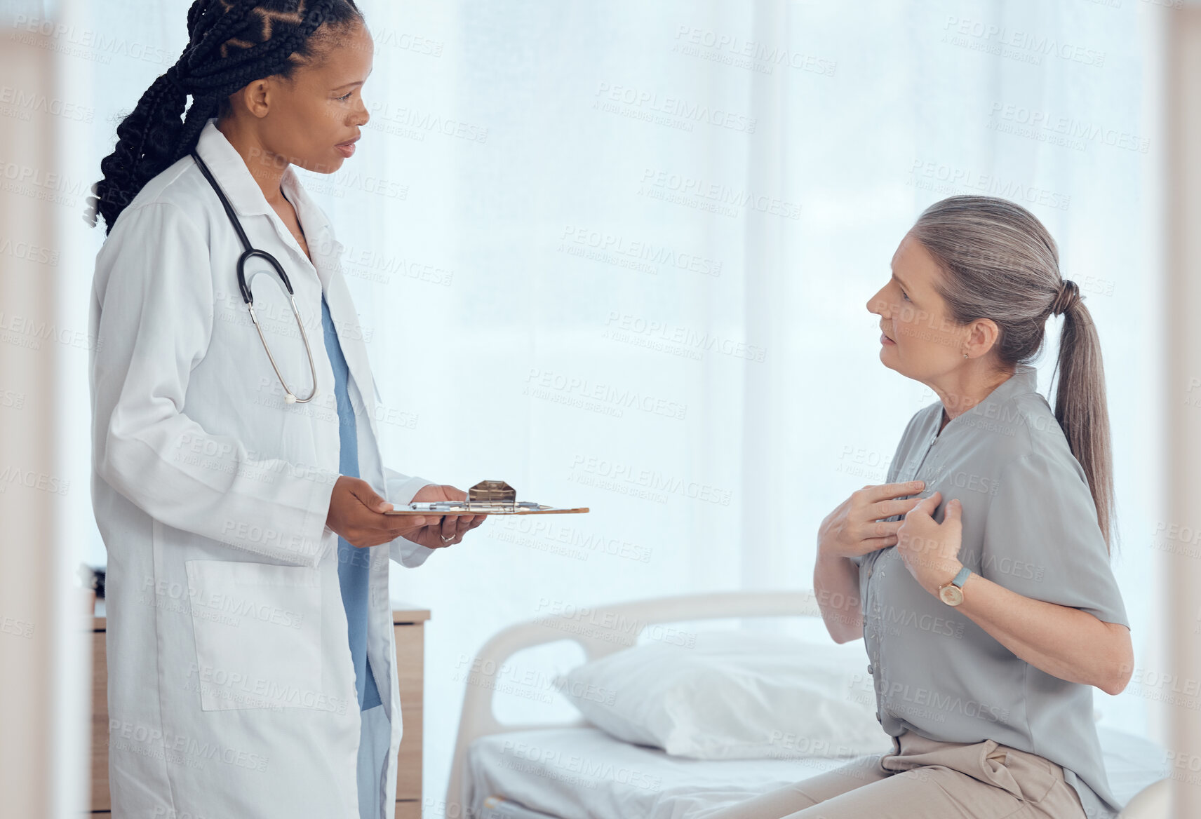 Buy stock photo Healthcare, consultation and doctor with senior patient in discussion on chest pain problem. Professional, clipboard and female medical worker talking to elderly woman with heart sickness in hospital