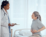 Medical, consultation and doctor with mature patient in discussion on chest pain problem. Professional, clipboard and female healthcare worker talking to elderly woman with heart sickness in hospital