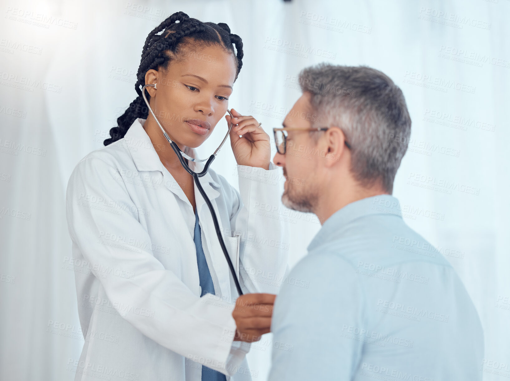 Buy stock photo Doctor, black woman listening with stethoscope to patient heartbeat, healthcare services and cardiology assessment in clinic. Medical worker check heart, lungs and breathing test of man in hospital