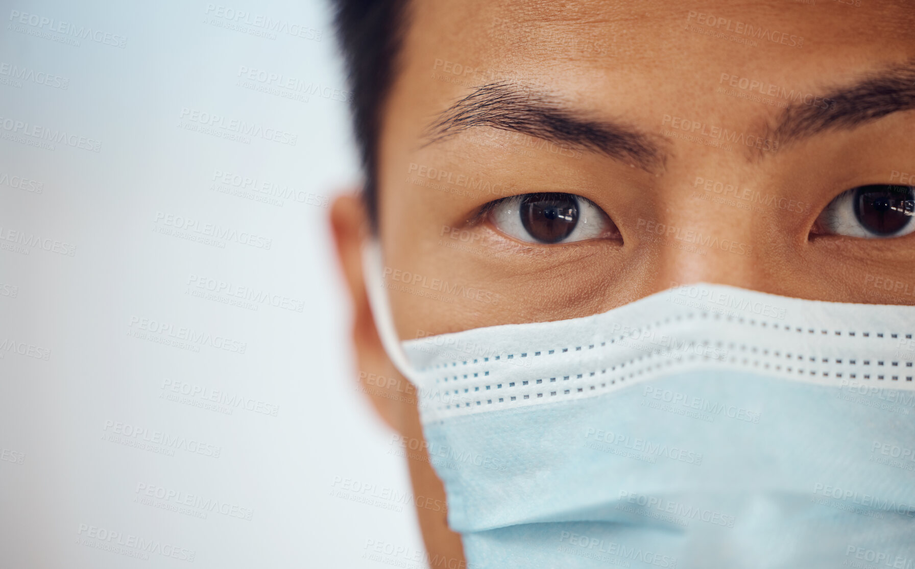 Buy stock photo Doctor, portrait and Asian man with mask, mockup banner and safety in healthcare in hospital on white background. Ppe, face and eyes of medical professional, rules and compliance work in clinic space