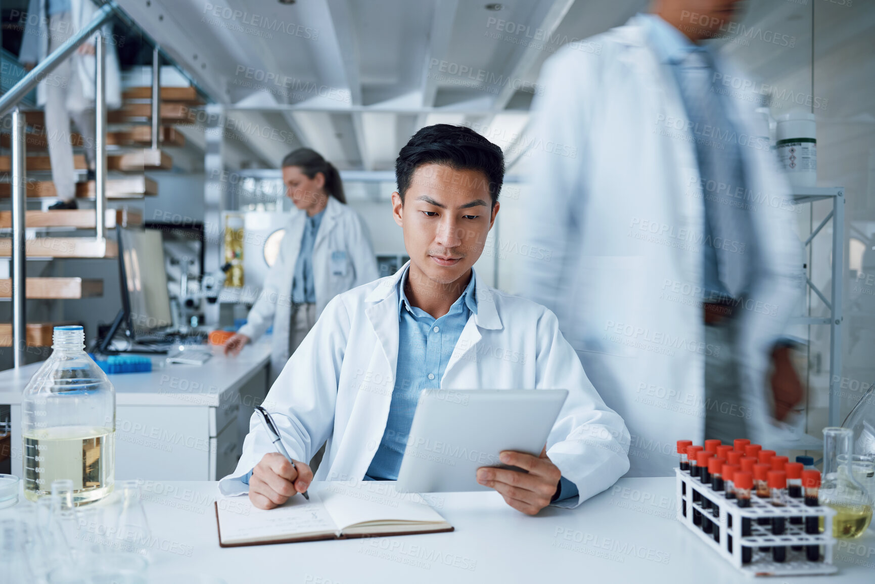 Buy stock photo Asian man, tablet and writing in science laboratory for medical virus research, medicine and vaccine development. Busy scientist, technology and notebook paper for blood sample healthcare or wellness