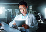 Tablet, hologram and scientist with digital innovation, data and 3d overlay in laboratory. Asian man, doctor and information technology for futuristic medical research with pharma healthcare study