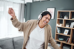 Senior, dance or happy woman streaming music or laughing to relax with freedom in home living room. Retirement, headphones or excited senior person listening to radio song or audio with joy or smile