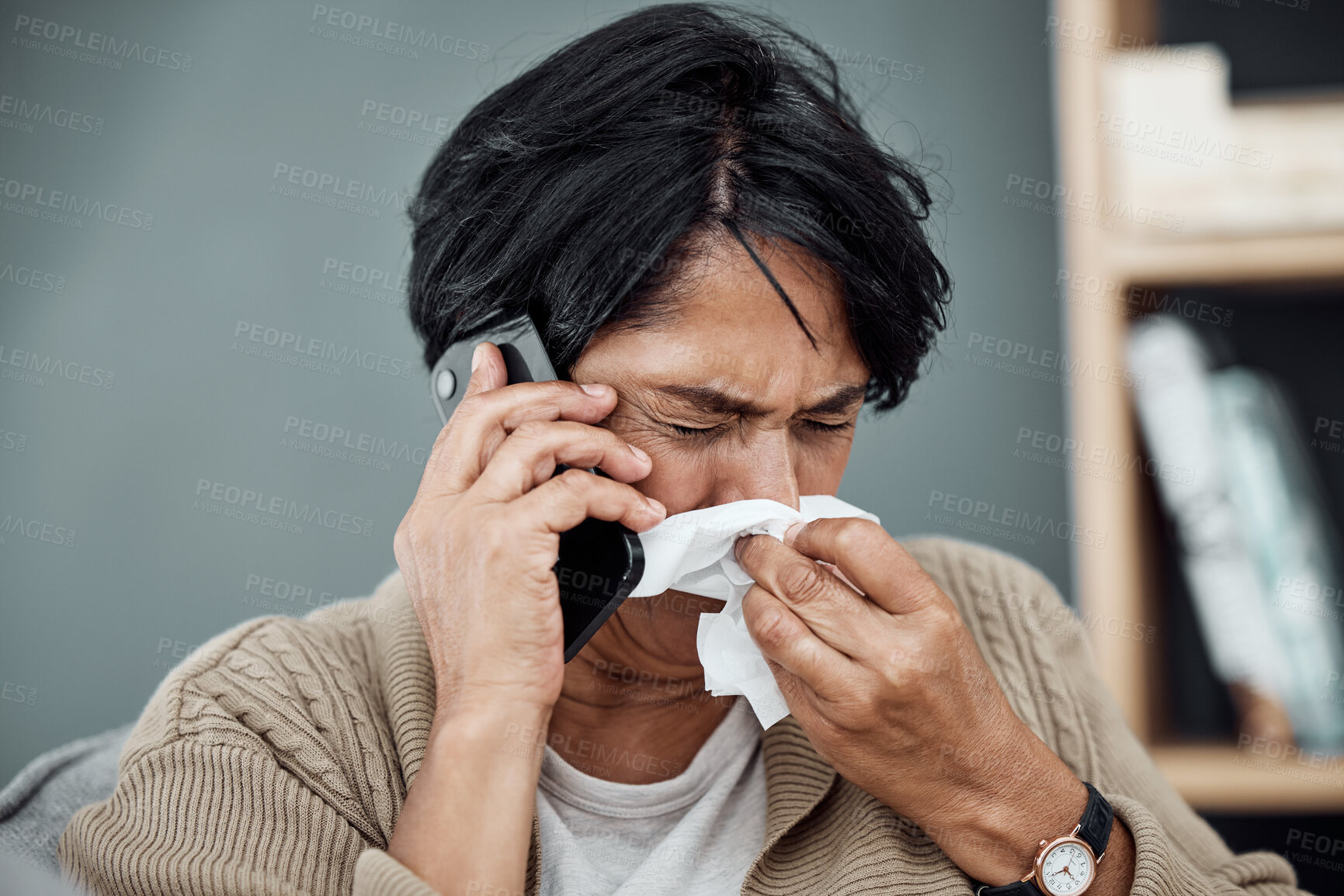 Buy stock photo Phone call, sick and woman blowing her nose for the flu, cold or sinus allergies at her home. Illness, telehealth and senior female person with tissue on a medical doctor consultation with cellphone.