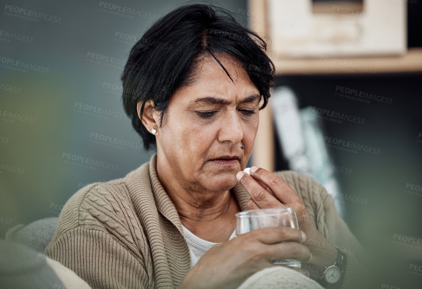 Buy stock photo Depression, drinking water or old woman in home to take pills, vitamins or supplements as medicine. Medical, sick or lonely senior person taking drugs or medication tablets for fatigue or anxiety 