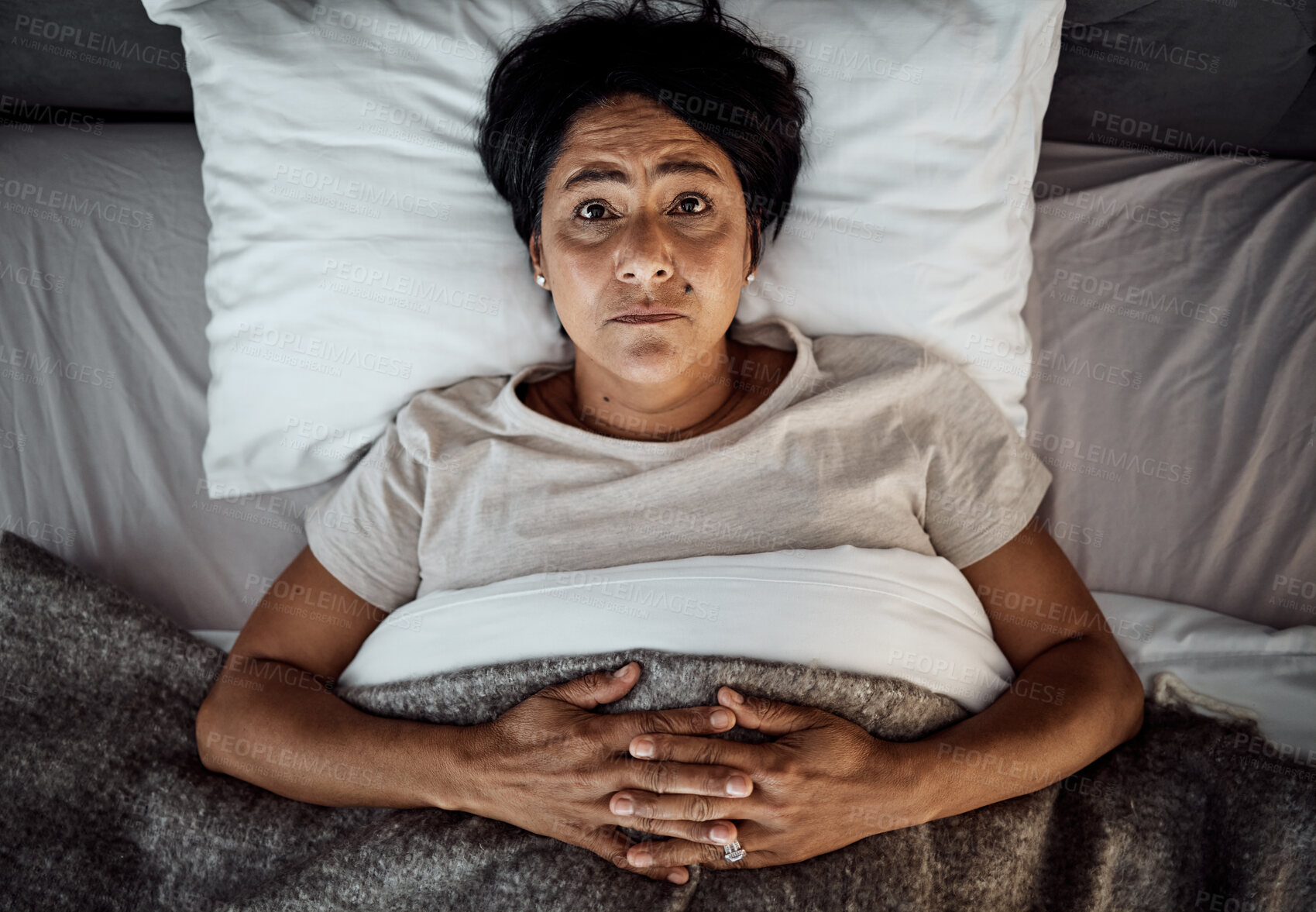 Buy stock photo Insomnia, portrait and senior woman in bed from above with menopause, anxiety or stress in her home. Top view, face and elderly female in a bedroom with depression, trauma or mental health crisis 