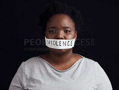 Buy stock photo Portrait, censorship and a black woman in protest of domestic violence on a dark background. Freedom, gender equality or empowerment with a serious young female person in studio for human rights