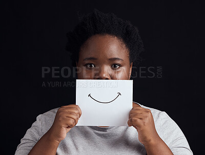 Buy stock photo Paper smile, portrait and a black woman on a studio background for mental health, problem or fear. Advertising psychology, poster and the face of an African patient or girl with bipolar or sad