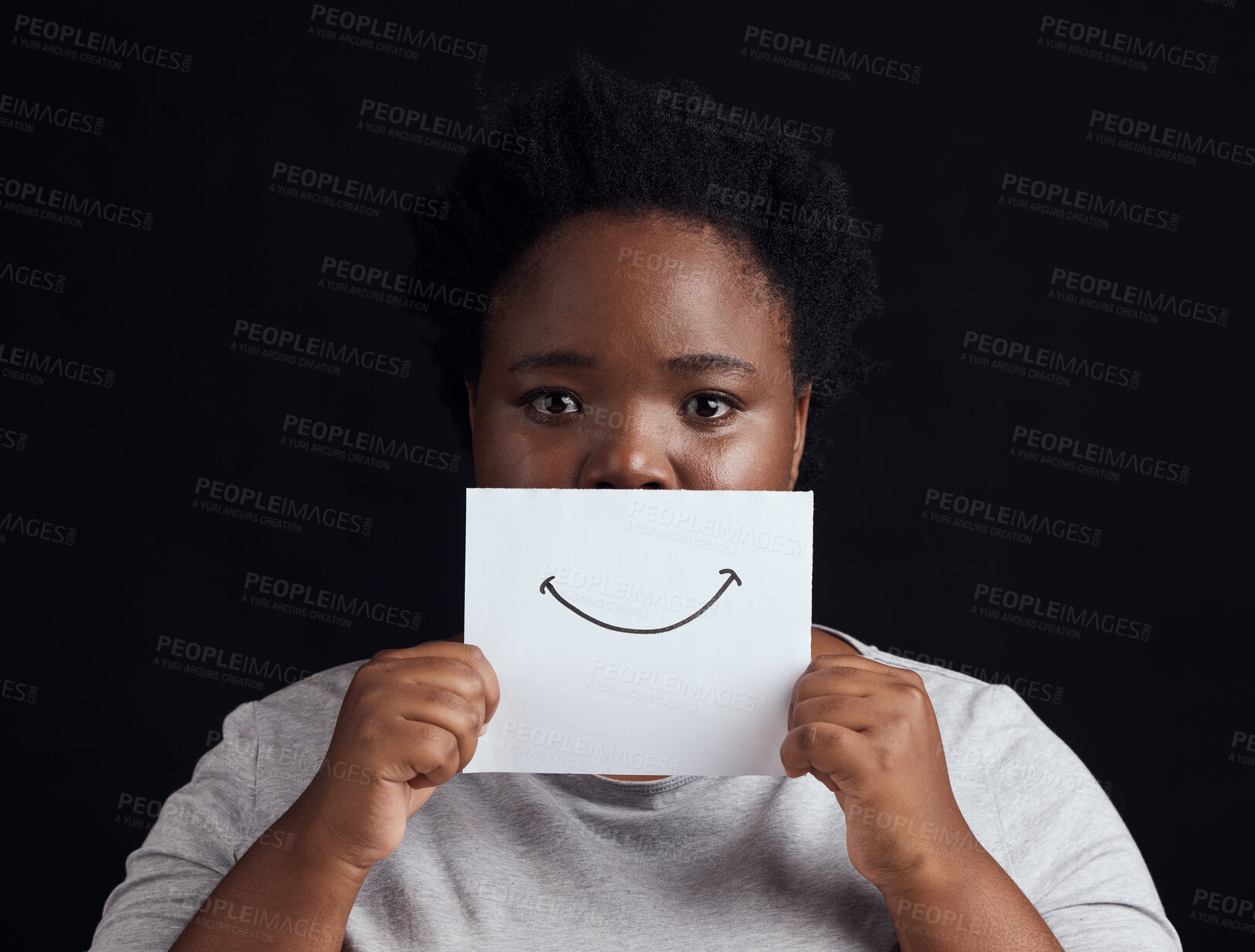 Buy stock photo Paper smile, portrait and a black woman on a studio background for mental health, problem or fear. Advertising psychology, poster and the face of an African patient or girl with bipolar or sad