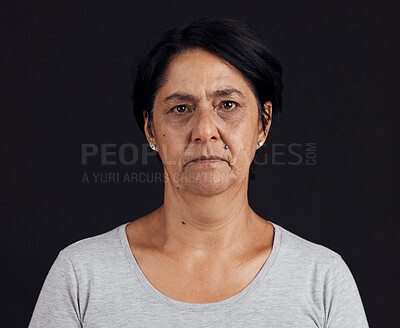 Buy stock photo Senior woman, portrait and mental health, depression and crisis with abuse isolated on black background. Sad, angry and anxiety with depressed female person, serious face and grief in a studio