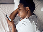 Stress, morning or black woman in bed with phone for social media lying in room for addiction at home. Insomnia, lonely or sad person reading online to scroll on mobile app in bedroom with depression