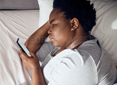 Buy stock photo Stress, morning or black woman in bed with phone for social media lying in room for addiction at home. Insomnia, lonely or sad person reading online to scroll on mobile app in bedroom with depression