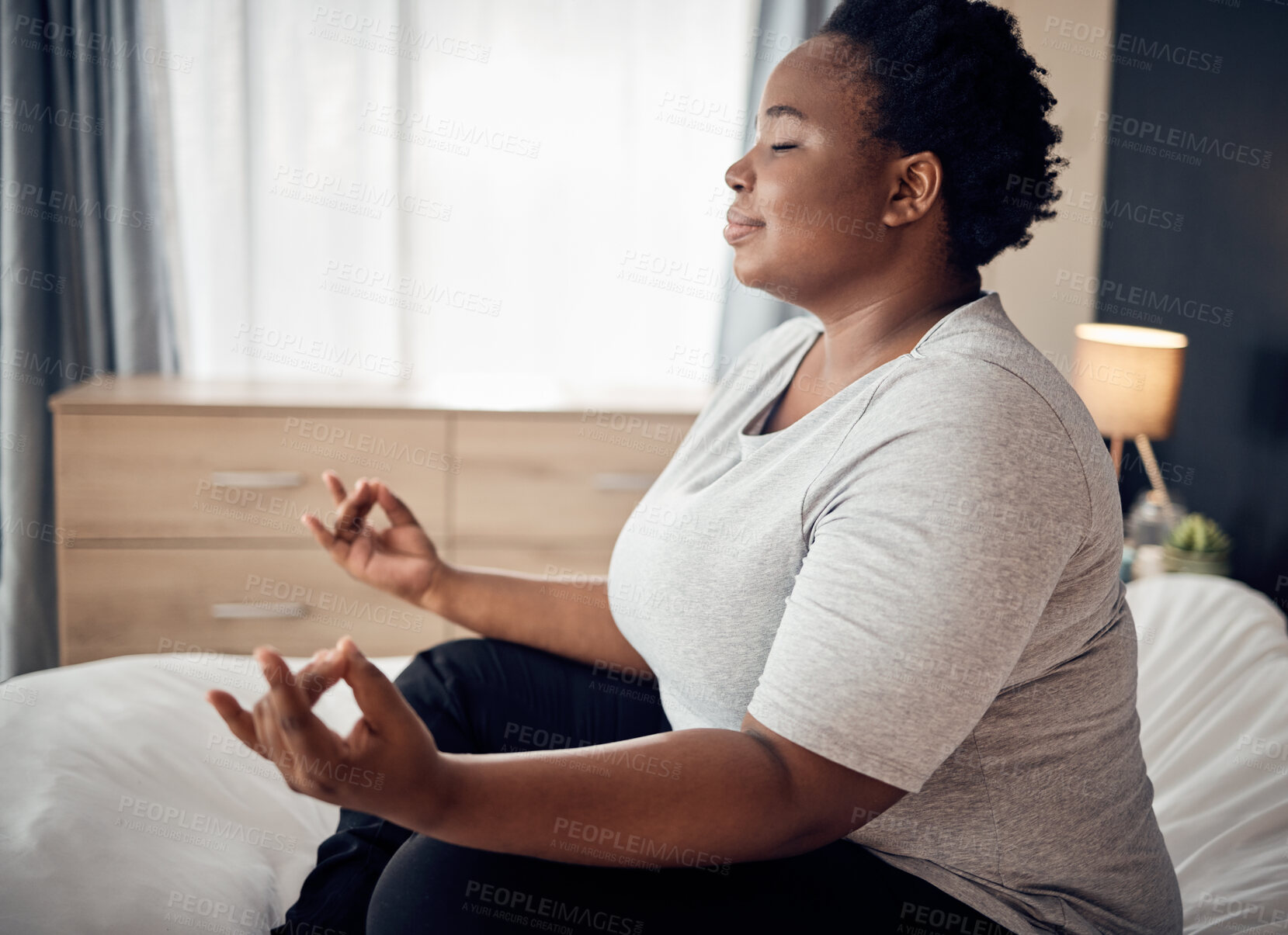 Buy stock photo Yoga, lotus and meditation of black woman on bed for peace, mindfulness or exercise. Pilates, workout and person in bedroom for zen, relax and health of plus size body, wellness and fitness at home