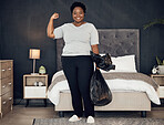 Black woman, garbage bag and champion, success in cleaning and bedroom with hygiene in portrait. Strong female cleaner, winner at housekeeping with smile, morning routine and maintenance at home