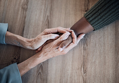 Buy stock photo Holding hands, support and counselling, help and trust with people, top view with psychology and people pray together. Kindness, respect and worship, therapy and wellness with communication and care