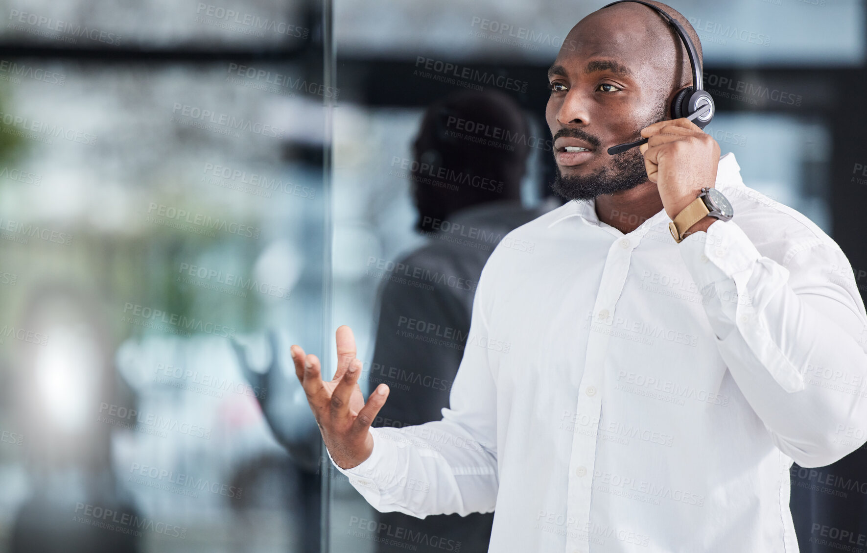 Buy stock photo Black man, microphone and consulting in call center for customer service, advisory help and FAQ questions. Serious salesman working in CRM agency for telecom solution, tech support and communication 