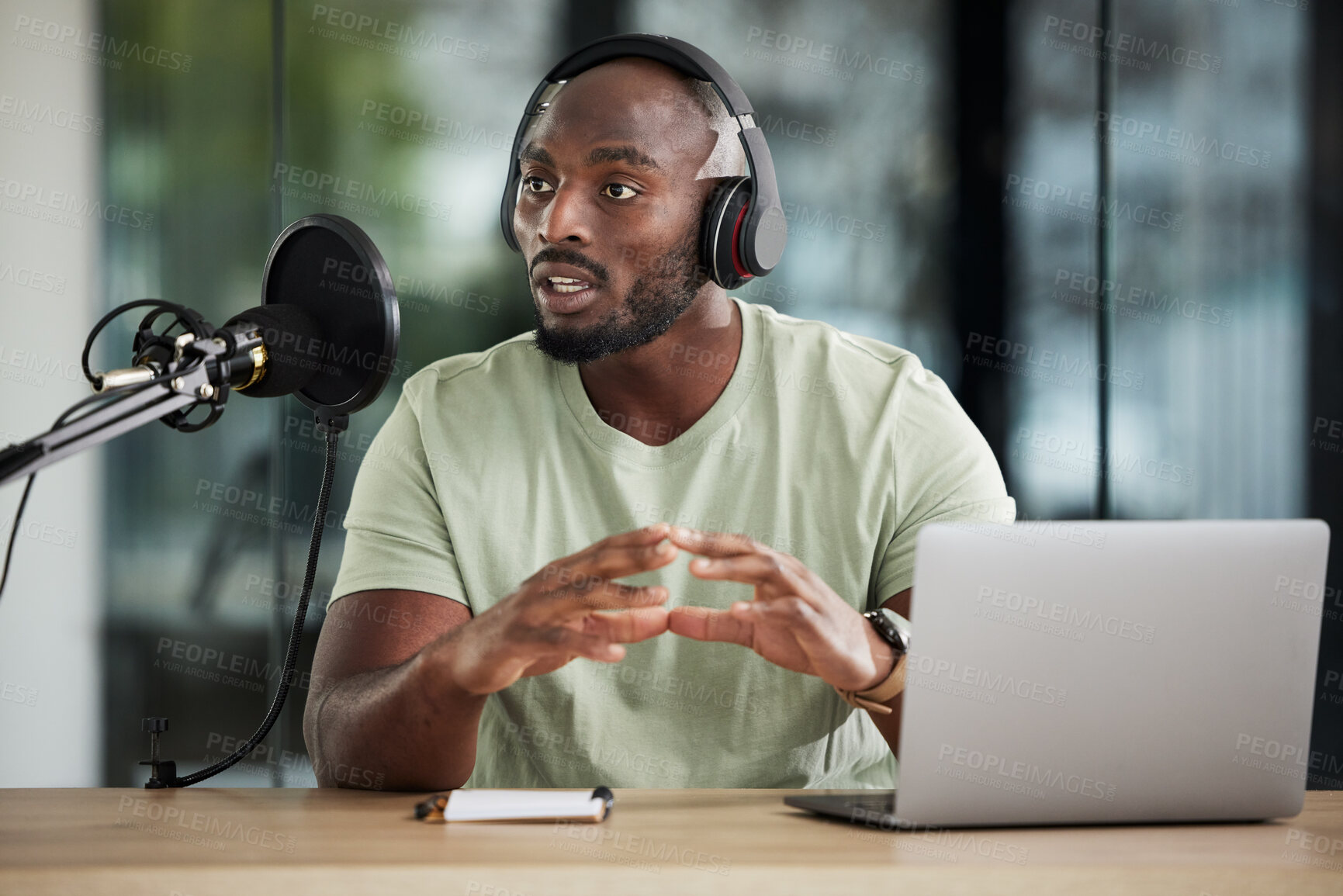 Buy stock photo Black man, microphone and talking with headphones and radio DJ, news with communication and audio equipment. Podcast, laptop and multimedia with male presenter, hosting show and online broadcast