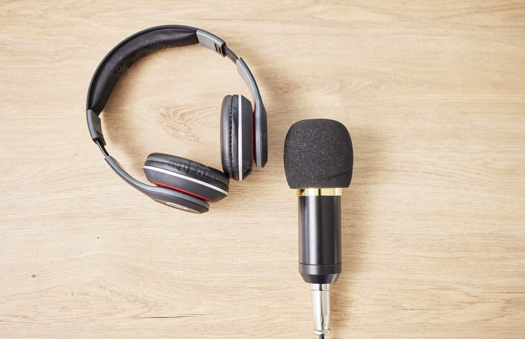 Buy stock photo Above, microphone and headphones on a table for a podcast, radio or broadcast. Music, desk or musical gear, equipment or a mic for live streaming, musician recording or technology in an office