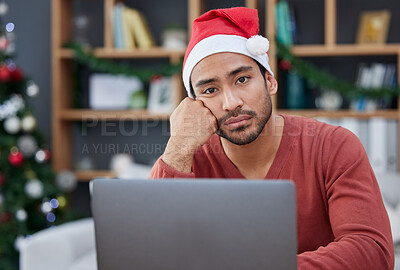 Buy stock photo Bored, christmas hat and portrait of a tired man in the office with a laptop working on a project. Burnout, exhausted and young male creative designer with xmas decorations in the modern workplace.