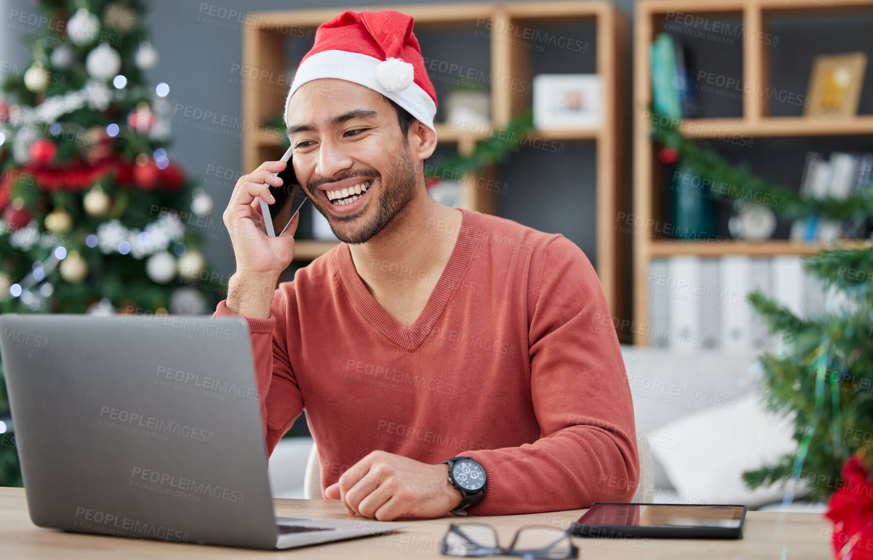 Buy stock photo Phone call, christmas hat and businessman in the office with a laptop on cellphone for communication. Happy, smile and male creative employee with xmas decorations on mobile conversation in workplace