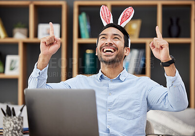 Buy stock photo Bunny ears, easter and celebration by business man excited, happy and winning in an office with success. Winner, rabbit and employee or person with victory, achievement and using a laptop for profit