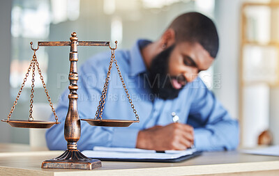 Buy stock photo Scale, notes and black man in office, lawyer or judge at desk with paperwork, research or crime report. Justice, icon and attorney at law firm writing in notebook, legal administration and contract.