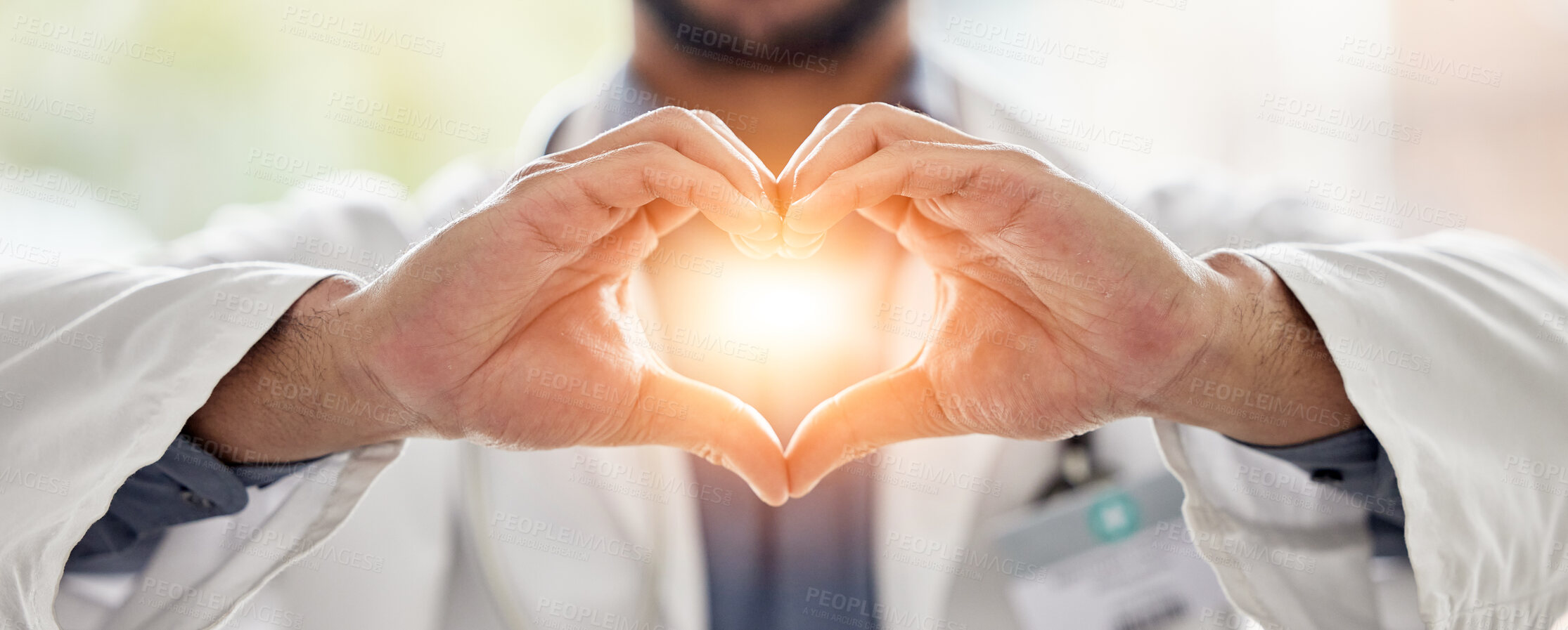 Buy stock photo Medical, light and doctor heart hands for love, support and healthcare in a hospital or clinic by medicine professional. Trust, hope and worker with bright sign, symbol or gesture for cardiology