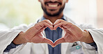Medical, wellness and doctor heart hands for love, support and healthcare in a hospital or clinic by medicine professional. Trust, hope and worker with bright sign, symbol or gesture for cardiology