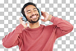 Headphones, moving and man doing a dance in studio to music, playlist or album for entertainment. Happiness, smile and Indian male model dancing to the radio or streaming a song by a white background