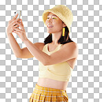 Selfie, beauty and smile of Asian woman in studio isolated on a yellow background. Makeup, fashion hat or young female model taking pictures or photo for social media, profile picture or happy memory