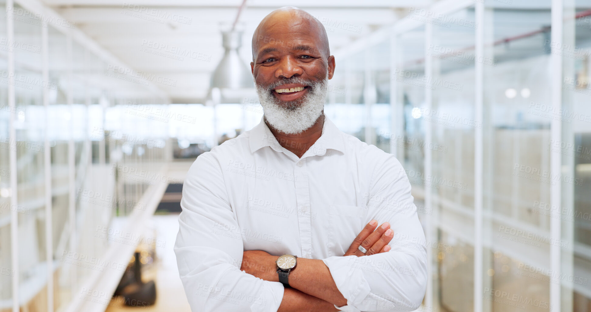 Buy stock photo Motivation, mindset and mission with a business black man standing arms crossed in his office at work. Portrait, happy and smile with a senior male manager or employee working with company vision