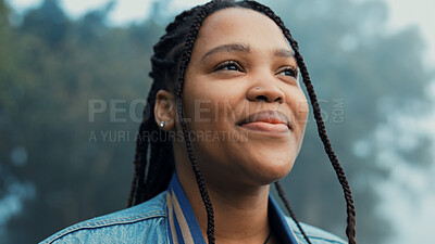 Face, thinking and a happy woman outdoor in nature to relax and breath fresh air to relax. Vacation, calm woods and closeup of a young african girl on a holiday or hike on misty morning with a smile
