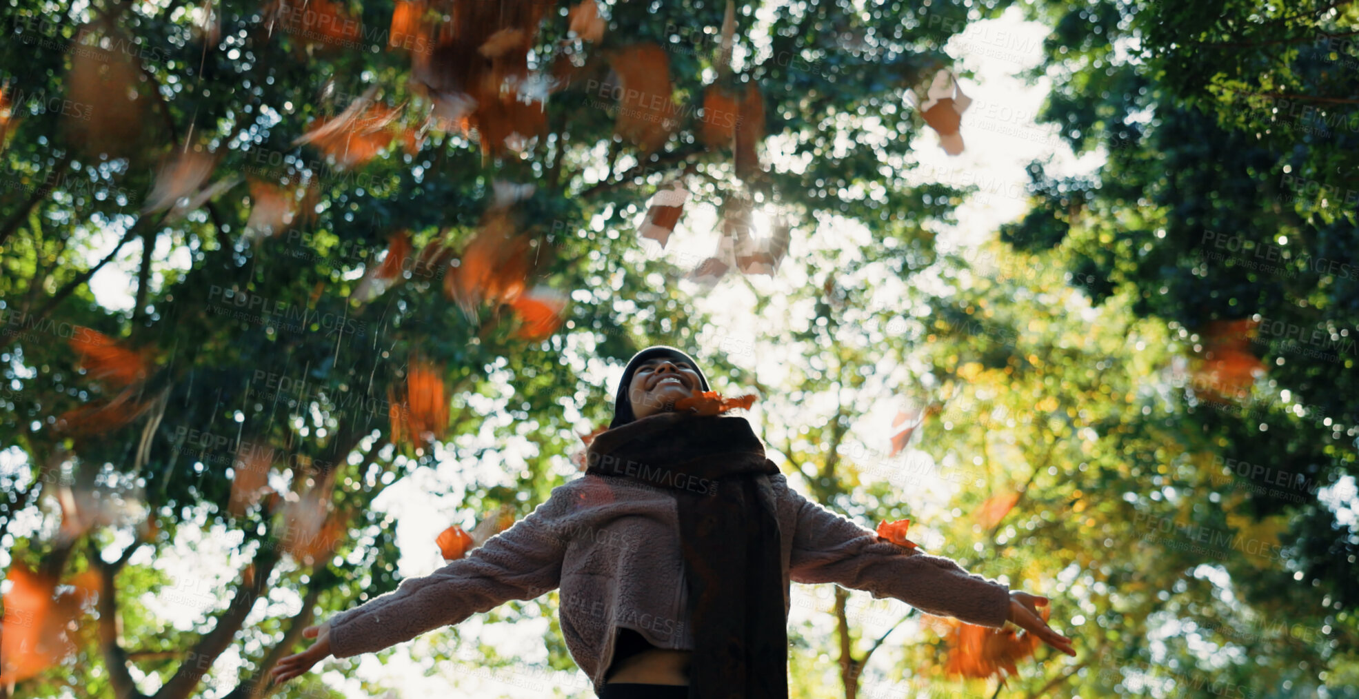 Buy stock photo Woman, autumn and leaves in air outdoor in a park with trees, freedom and fun in nature. Happy and excited person in warm clothes while playful on an adventure, travel or holiday in fall season