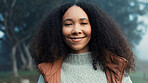 Portrait, face and a happy woman outdoor in nature to relax and breathe fresh air. Vacation, calm woods and closeup of a young african girl on holiday or hike on misty morning with a confident smile