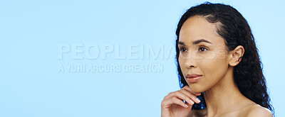 Skincare, woman and thinking face in studio for beauty, dermatology and mockup ideas on blue background. Young female model dream of cosmetics, aesthetic wellness and vision of facial transformation