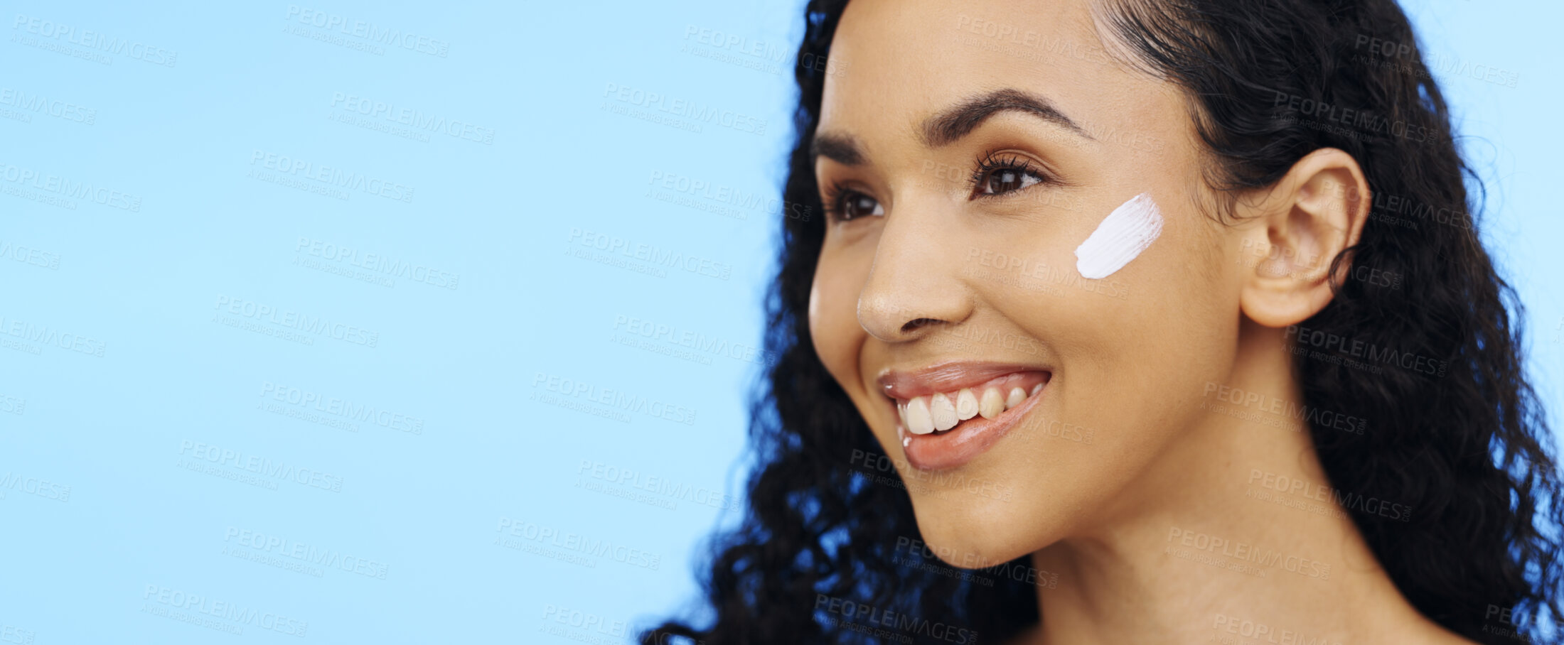 Buy stock photo Woman, face and brush cream for skincare, aesthetic salon and beauty on blue background. Happy studio model, facial lotion and makeup cosmetics for dermatology, collagen mask and smile of happiness