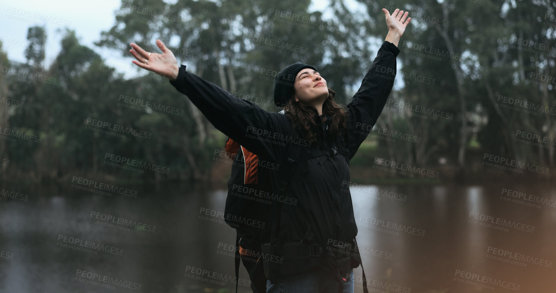 Buy stock photo Hiking, celebration and woman with freedom in nature for adventure or achievement of peace in forest with lake. Travel, trekking and girl stretching with success, inspiration and journey on holiday