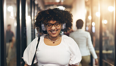 Headphones, happy and face of a woman in the office walking with her colleagues to her desk. Greeting, smile and portrait of a female creative designer listening to music, radio or song in workplace.