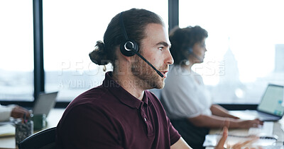 Call center, customer service and a man talking on headset in a coworking office for crm or advice. Male consultant for contact us, technical support and help desk or sales agent for telemarketing