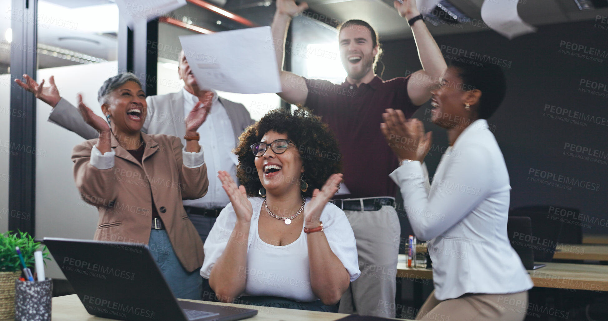 Buy stock photo Team throwing paper, applause and woman at desk with pride, celebration and happy achievement for business people. Success, cheers and smile, excited group of employees in office at laptop with news.