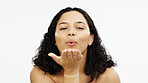 Skincare, happy and portrait of a woman blowing kiss isolated on a white background in a studio. Flirty, happiness and a girl with affection, flirtatious smile and gesture of love on a backdrop