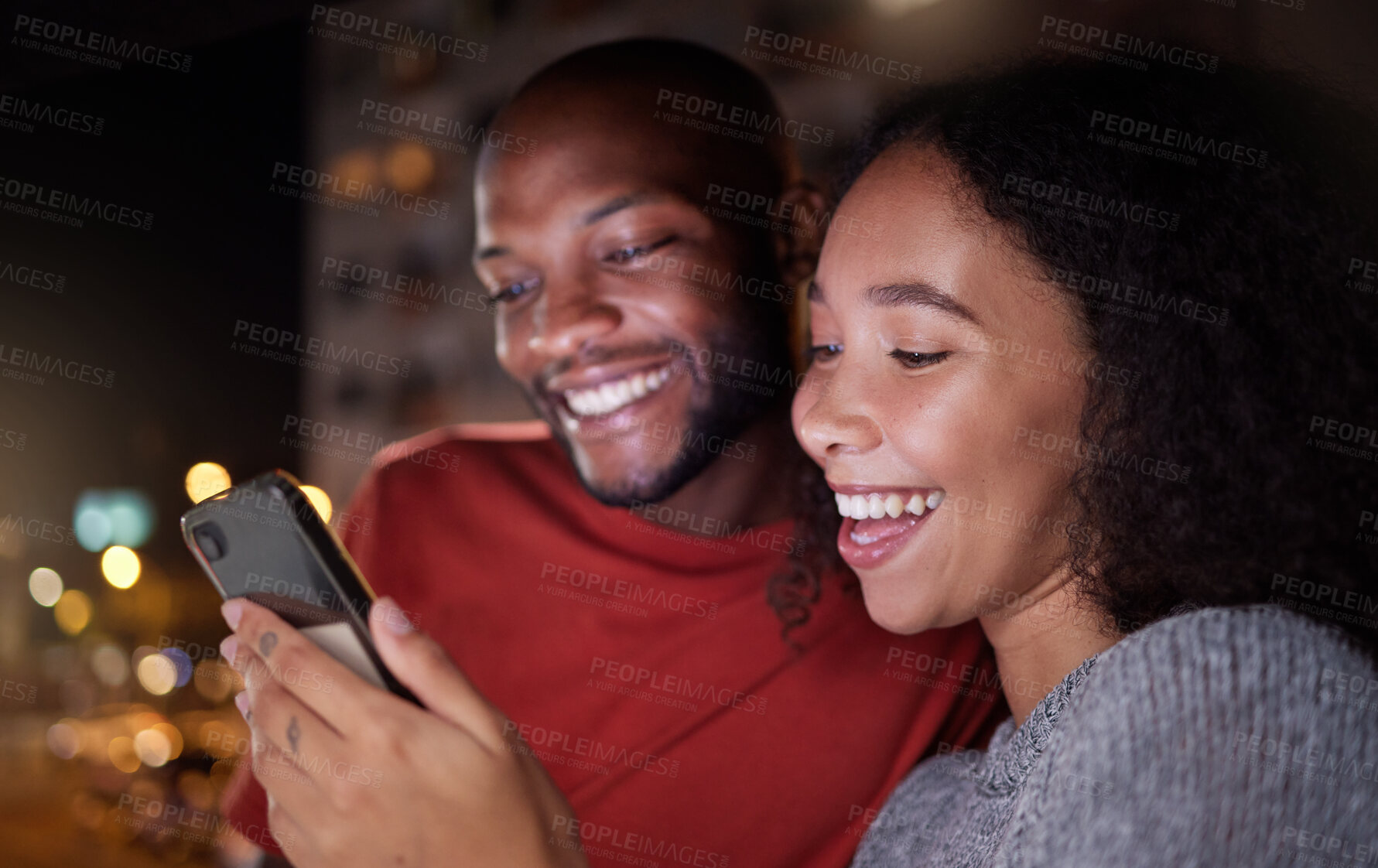 Buy stock photo Phone, social media and funny couple in the city at night for love, freedom or fun together. Face, meme or mobile with a black man and woman in an urban town to enjoy nightlife while bonding
