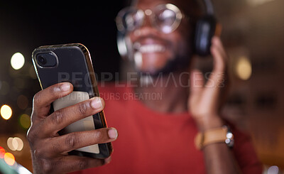 Buy stock photo Man hands, phone and music in a city at night with online streaming and audio. Podcast, web radio and internet broadcast with a African male person smile and mobile networking feeling happy with text