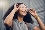 Woman, smile and city travel of student with glasses on a street with vision of future dream. Urban, university holiday and happy young African person walking with backpack on adventure or vacation