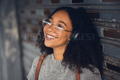 Buy stock photo Thinking, music and smile with a woman in the city, streaming or listening to the radio using headphones. Face, idea and audio with a happy young female person hearing sound in an urban town