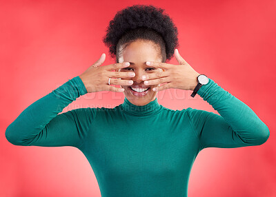 Buy stock photo Hands, cover face and woman in studio with hiding and eyes peak with a smile. African female person, red background and happy with secret and model from Chicago with gossip announcement and portrait